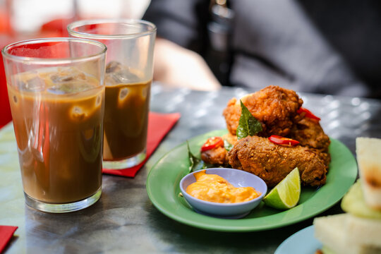 Crispy fried chicken with chili and lime served with iced coffee drink