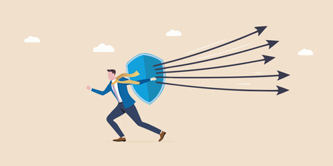 Businessman defends against incoming arrows with a shield