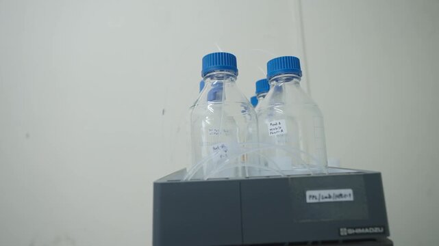 Laboratory Reagent Bottles Connected to Analytical Instrument