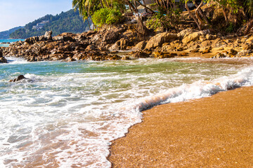 Rocky Kalim Beach tropical landscape panorama in Patong Phuket Thailand.