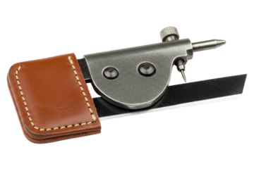 Leather skiving tool with sharp blade and brown cover on isolated background