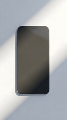 Sleek smartphone with a dark screen on a light surface.
