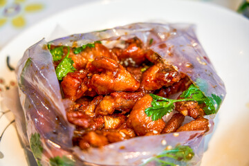 Sweet and rich flavor of paper-wrapped pork ribs, a traditional dish from Guangxi, China