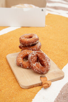 Apple Cider Donuts on a Wooden Board With a Cozy Background