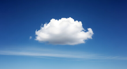 A single cumulus cloud floating in a bright blue sky with light wispy clouds below it in the distance