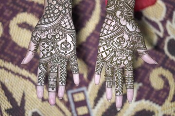 A traditional Bengali woman decorated mehendi on both hands during 
