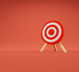 Red and white target on wooden stand against solid background for focus and accuracy concept