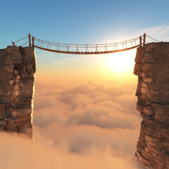 Suspended wooden bridge connects two cliffs at sunrise above a sea of clouds