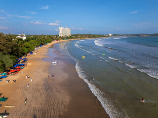 Aerial view of Weligama Beach with surfers riding the waves, Sri Lanka