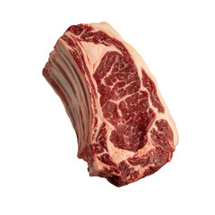Obraz premium Raw beef ribeye steak with bone and marbling on black background isolated on a transparent background