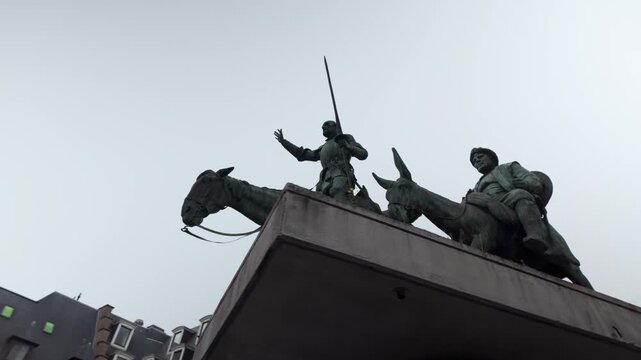 Low-angle view of the bronze monument depicting Don Quixote and Sancho Panza on the Place d'Espagne in Brussels, Belgium