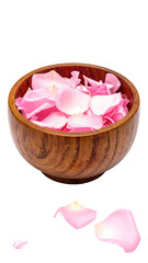 Pink rose petals in wooden bowl, some spilled out