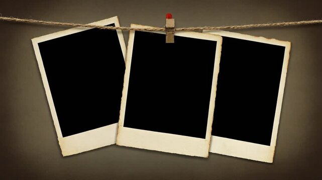 Three vintage style photo frames hanging on a rope with a wooden clothespin against a dark neutral background.