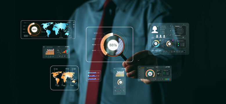 Businessman using a magnifying glass to analyze holographic data charts and global maps. Concept of business analytics, digital technology investigation, and financial market research.