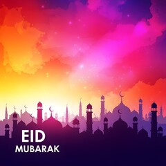 Eid mubarak greeting card design with mosque silhouette against a vibrant, colorful gradient sky at sunset or dawn