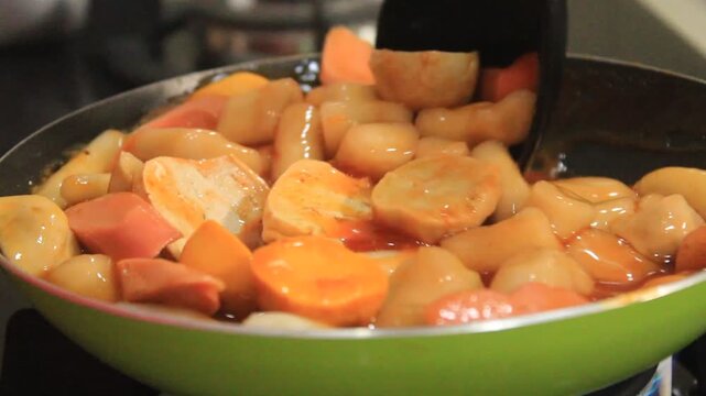 Someone stirs up Korean specialties. spicy Korean specialties