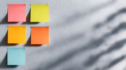 Colorful Sticky Notes: A composition of brightly colored sticky notes attached to a plain surface, showcasing diverse hues and serving as a canvas for creativity and planning.