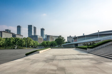 Modern Urban Skyline with Lush Greenery and Expansive Pavement Spaces