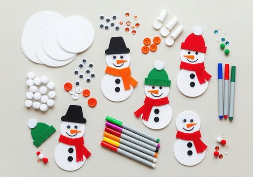 Top view of a collection of diy snowman craft supplies and finished snowmen for winter holiday activities