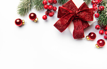 Christmas gift box with festive red decorations on white