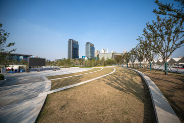 Serene Urban Park with Modern Architecture in Bright Blue Sky