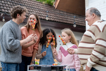 Multiracial family having fun and enjoying party outdoors in garden