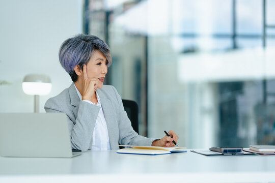 portrait of Asian senior businesswoman thinking work idea in office