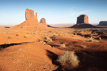 Fototapeta premium Sunset at Monument Valley Navajo Tribal Park in Arizona and Utah, United States of America. Sandstone towers illuminated by the sun. The most popular place in Utah. Summer time and summer season