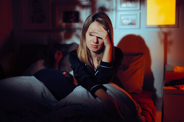 Sad Wife Unable to Sleep Next to Her Husband. Dysfunctional couple not having a good relationship while being together