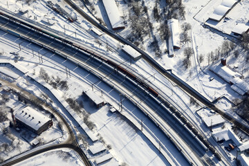 Aerial view of train moving on railway track in winter landscape