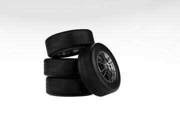 Stack of four glossy black automotive tires or wheels