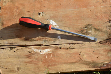 Screwdriver on a rustic wooden surface