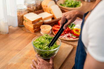 Close up of man cooking healthy foods in kitchen in morning at home. 
