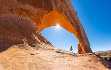 Wilson Arch is a natural sandstone arch in southeastern Utah, United States, just off U.S. Route 191 in San Juan County. It is located near the town of Page. Summer day with blue skies.