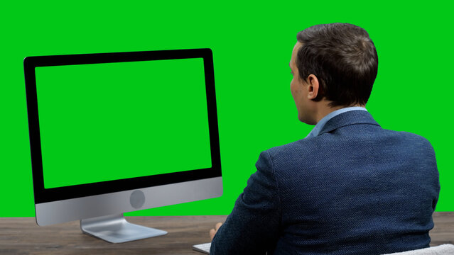 Businessman having online business conference video call on green screen