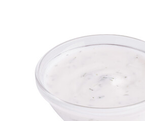 Creamy white dip with herbs in a glass bowl on a plain background