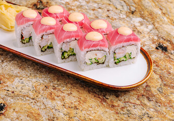 Sushi platter with fresh rolls and wasabi on a marbled surface