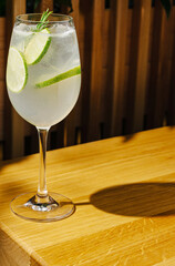 Refreshing citrus drink served in a glass on a wooden table