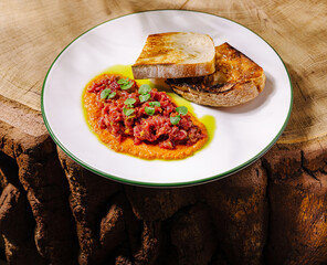 Delicious dish with toasted bread on a rustic wood surface in natural lighting