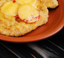 Delicious fried plantains topped with melted cheese and sliced peppers