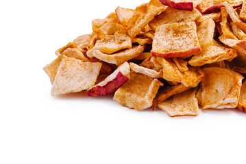 Crispy apple chips stacked on a clean surface in bright light
