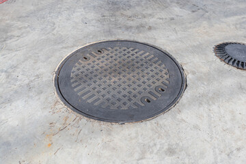 Steel manhole cover, round manhole cover on concrete floor