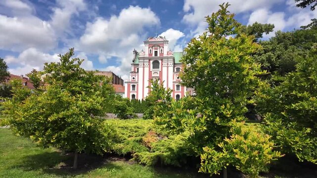 Walking in the park around Parish Church of St. Stanislaus (Fara Church) in poznan, Poland