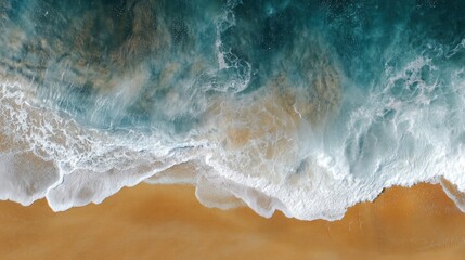Fototapeta premium Aerial view of a beach with waves crashing onto the sand. the water is a beautiful shade of blue and green, with white foam and spray visible on the surface.