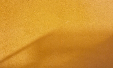 background of orange  wall in sunlight with shadow