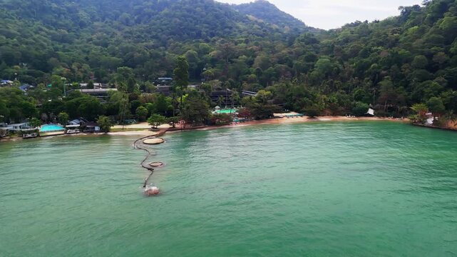 Aerial drone footage capturing the tranquil Bailan Village, beach, and tropical resorts on Koh Chang, Thailand