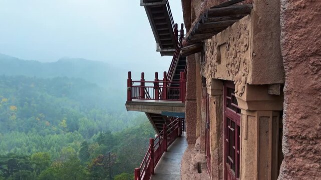 Wooden Walkways And Stairs Onto The Cliff Face At Maijishan Grottoes Near Tianshui City in China's Gansu Province. Pan Right Shot
