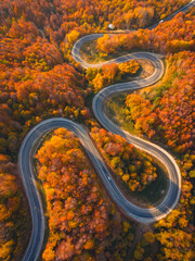 Aerial view of cars driving on the forest road between Domanic and Inegol in autumn, taken with a drone
