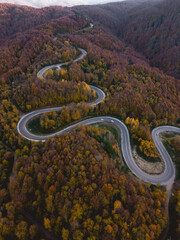 Aerial view of cars driving on the forest road between Domanic and Inegol in autumn, taken with a drone