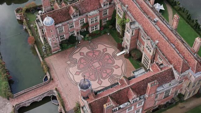 Kentwell hall aerial Birdseye view circling mansion Tudor rose mosaic courtyard and moat in Suffolk